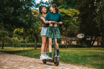 Girls riding electric scooter and feeling excited