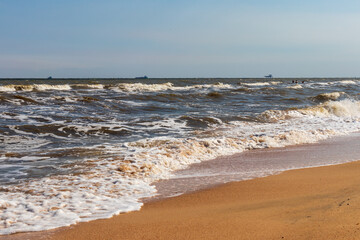 The Black Sea in sunny weather. Surf on the beach, waves,sandy shore