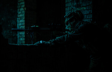 Marksman in action in the ruined city under cover of darkness