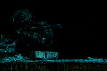 Marksman in action in the ruined city under cover of darkness