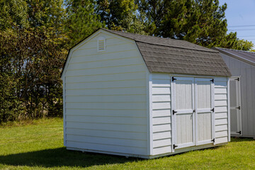 Fototapeta na wymiar Wooden storage shed for gardening tools in backyard