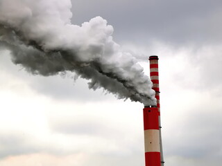 Air pollution, smoke clouds from a high concrete chimney