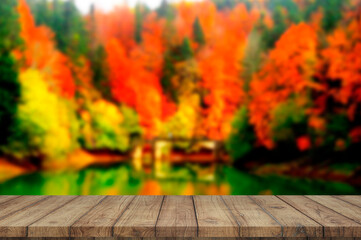 Naklejka na ściany i meble Wooden board empty table blurred autumn background used for display products