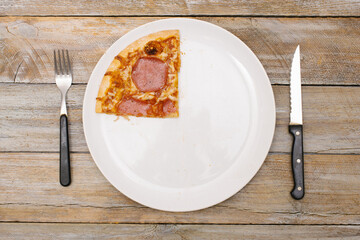 One quarter - Pizza pieces series as illustration of division in maths on wood table