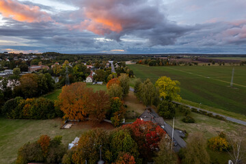 Beautiful aerial view of a little village in Sweden, stormy weather and sunset, rural landscape