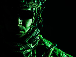 Elite member of US Army ranger in combat helmet and dark glasses. Studio shot, dark black background, looking at camera, dark contrast, toned and colorized
