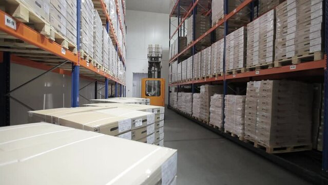 Warehouse storage of goods for distribution to customers, pallets on shelves in a logistics center. Delivery of goods to supermarkets