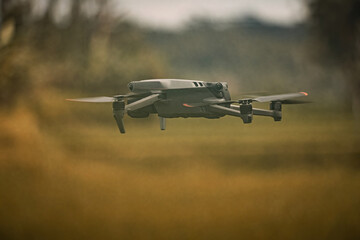 Drone in the air with blurry grass background