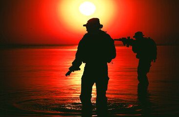 Army soldiers with rifles orange sunset silhouette in action during raid crossing river in the water, two militants with rifles