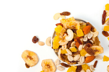 Fruit and nut assortment of peanuts, raisins, pineapple, almonds, cashews and bananas.