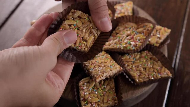 Desserts with almonds, peanuts and seeds in caramel. Traditional Sardinian sweet. Sweet squares. High quality 4k footage. Almond Gateau, sarda Food, for smartphones and social networks