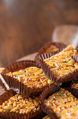 Desserts with almonds, peanuts and seeds in caramel. Traditional Sardinian sweet. Sweet squares. Almond Gateau, sarda Food, for smartphones and social networks. Copy space. Vertical