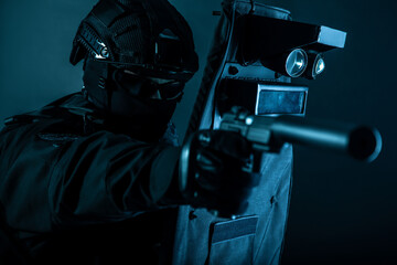 Police special forces fighter, assault team member, tactical group officer in black uniforms,...