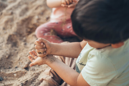 Two Kids Playing On Sandpit Spending Time In Games, Having Fun. Summer Activities. School Yard With Kids. Healthy Activity. Happy Family, Childhood. Summer