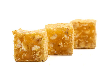 Turkish delight isolated on a white background. Turkish delight with orange flavored hazelnuts. Traditional Turkish delicacies. close up