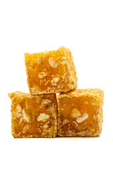 Turkish delight isolated on a white background. Turkish delight with orange flavored hazelnuts. Traditional Turkish delicacies. close up