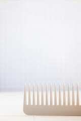 The beauty of a close-up hair comb on a white isolation background. Vertical orientation.