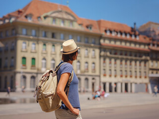 Woman having a great vacation in Switzerland, BErn, Federal palace. Lady visiting tourist attractions and landmarks.