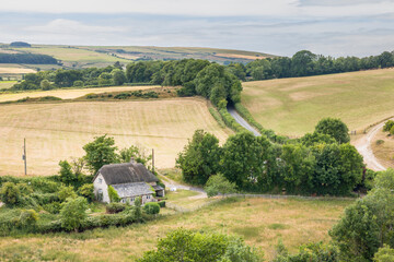 Thatched cottage in Dorset landscape, UK