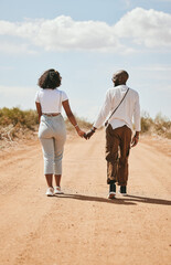 Black couple, love and holding hands back view in nature walking on vacation on desert, sand or...