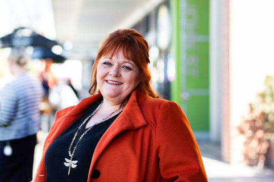 Portrait of a happy middle age lady in urban setting