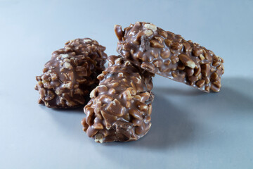 Chocolate candies with nuts on a light background