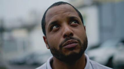 Obraz premium Portrait of a sad pensive black man. Thoughtful depressed African American young person face