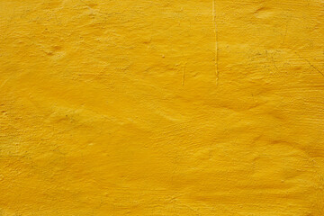 Fototapeta premium rough plaster wall painted bright yellow background