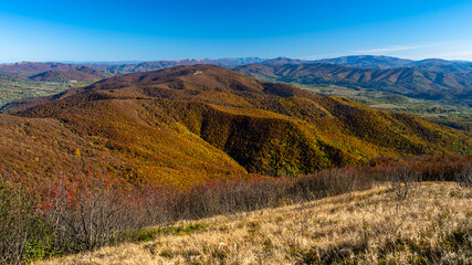 Ukrainian part of the Bieszczady Mountains seen from the Mount Wielka Rawka in the Bieszczady National Park. Colorful autumn mountain landscape
