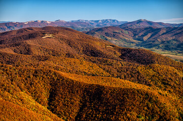 Naklejka premium Ukrainian part of the Bieszczady Mountains seen from the Mount Wielka Rawka in the Bieszczady National Park. Colorful autumn mountain landscape
