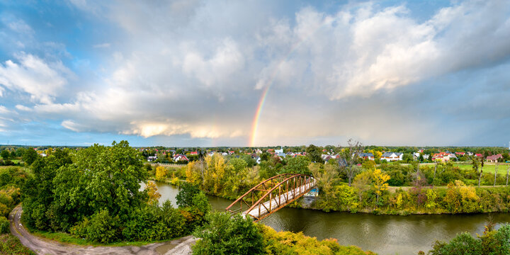 A rainbow after the storm over the bridge aerial panorama shot.