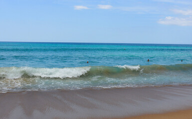 Warm waves of a tropical beach wash the sand