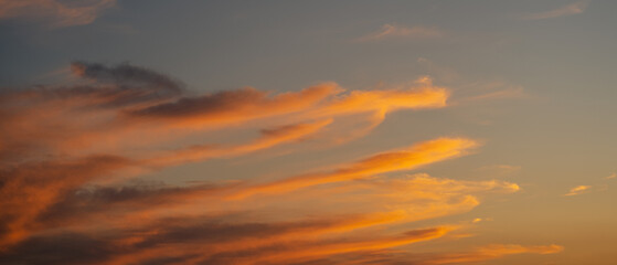 Sunset sky with orange clouds. Nature background.