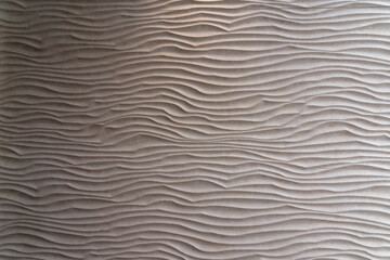 Stone waves, beautiful three-dimensional wave structure worked in beige colored stone slab. Copy space for your design or product. Web banner.