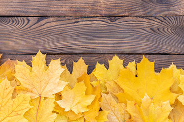 Autumn leaves frame on wooden background top view Fall Border yellow and Orange Leaves vintage wood table Copy space for text.