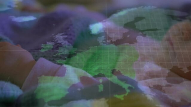 Animation of world map over caucasian baby sleeping