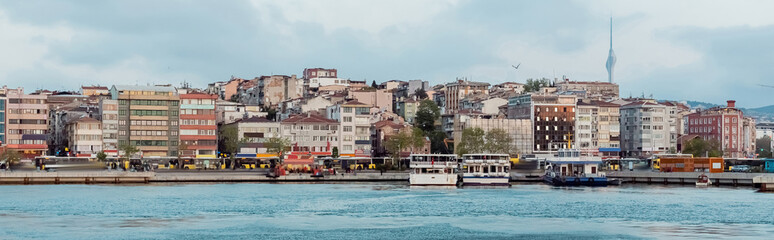 different ships and boats on pier near buildings in istanbul, banner.