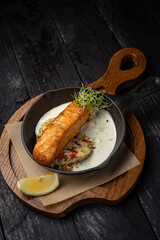delicious grilled salmon in the restaurant. On a dark background

