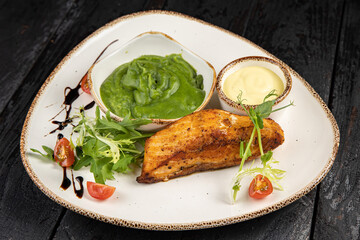 delicious grilled salmon in the restaurant. On a dark background
