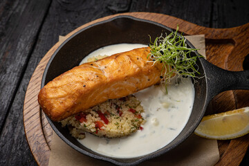 delicious grilled salmon in the restaurant. On a dark background
