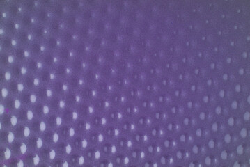 The texture is made of purple metal with many indentations. Closeup