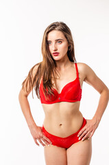 Obraz premium Beautiful, sexy, elegant blonde woman in red lingerie on a white background