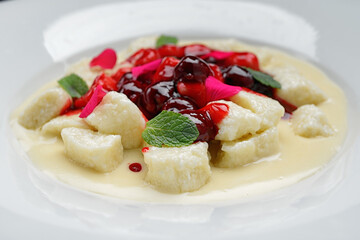 Lazy dumplings with cherries in sour cream