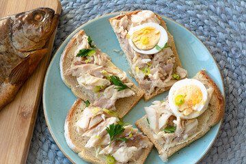 Sandwich with smoked trout and egg for breakfast