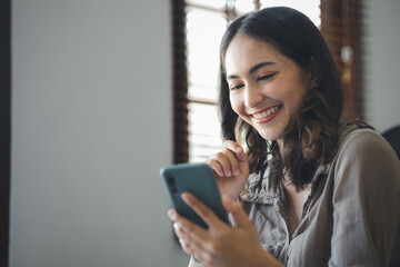 young businesswoman looking at financial information from a mobile phone, she is checking company financial documents, she is a female executive of a startup company. Concept of financial management.