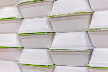 White containers with instant noodles on the shop window. White boxes of doshirak noodles are stacked on top of each other, fast food, a place for text.