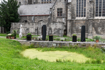 Fototapeta na wymiar Kortrijk, West Flanders Region - Belgium - Green grass and garden of the catholic church