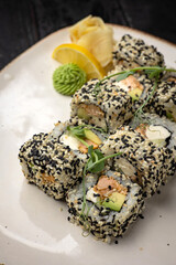 sushi roll with wasabi and sesame seeds on the plate. delicious food, close-up