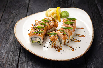 sushi roll with wasabi and sesame seeds on the plate. delicious food, close-up