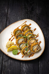 sushi roll with wasabi and sesame seeds on the plate. delicious food, close-up